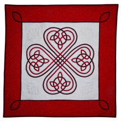 Red and white quilt featuring 4 Celtic knot hearts.